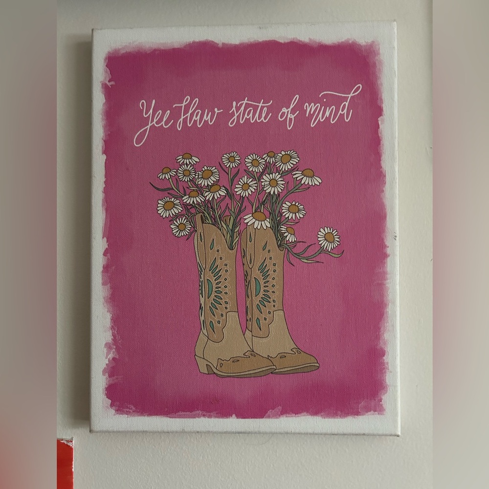 Canvas that is pink and white that says “YEEHAW STATE OF MIND”